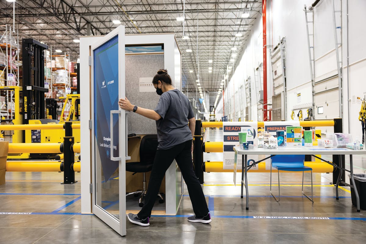 An employee enters an AmaZen kiosk, where employees can watch interactive mindfulness practices.