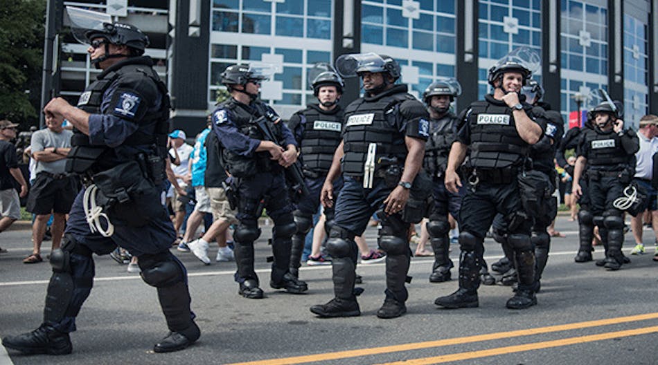 Police in riot gear walk outside Bank of America Stadium before an NFL football game between the Charlotte Panthers and the Minnesota Vikings Sept. 25 in Charlotte, N.C.